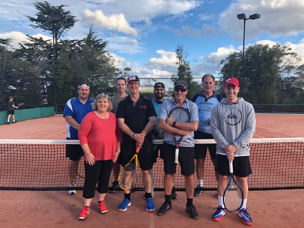 A pennant team at the net on the clay courts at Domain Tennis Centre