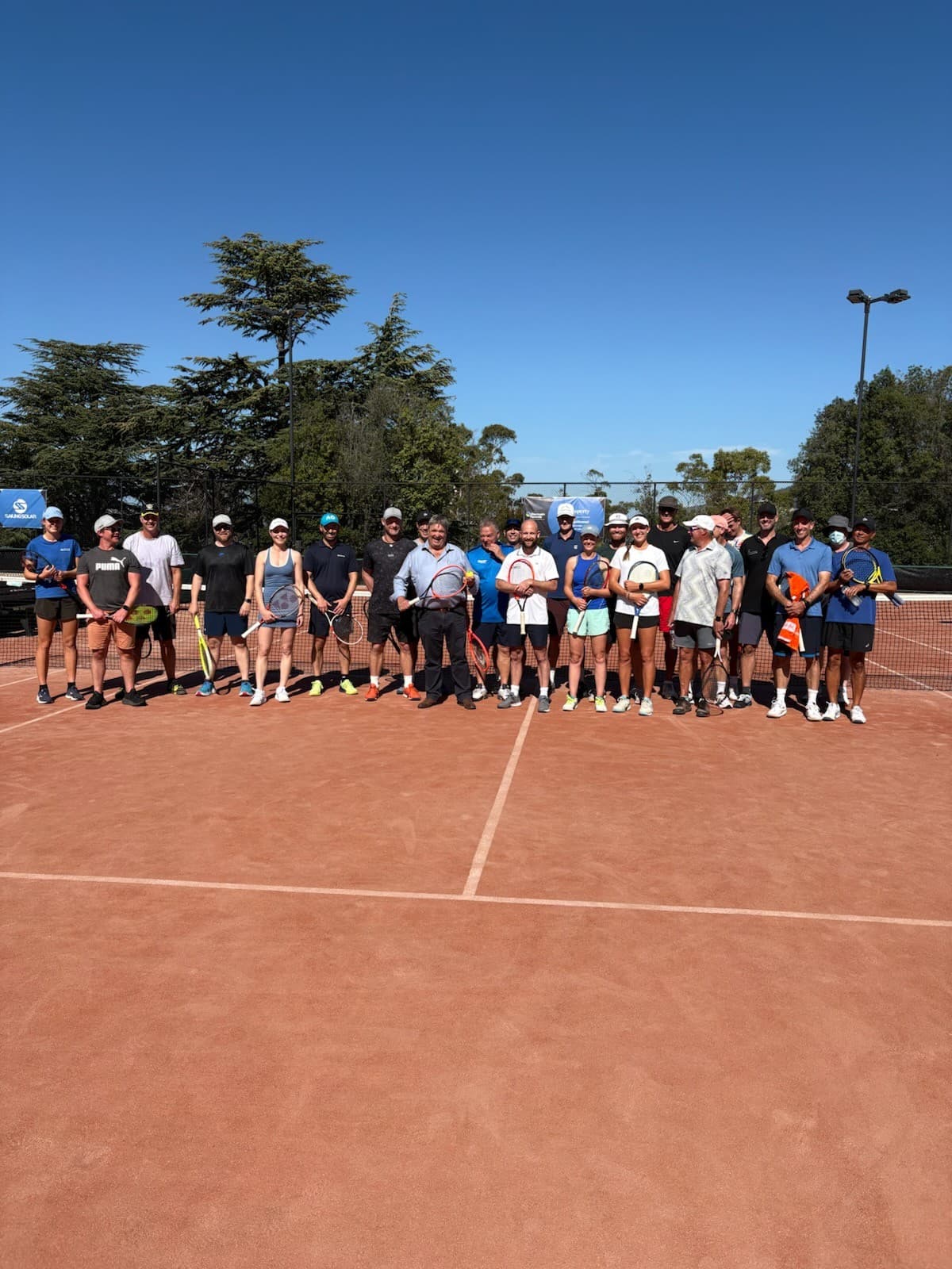 Players lined up on a court at Domain Tennis Centre